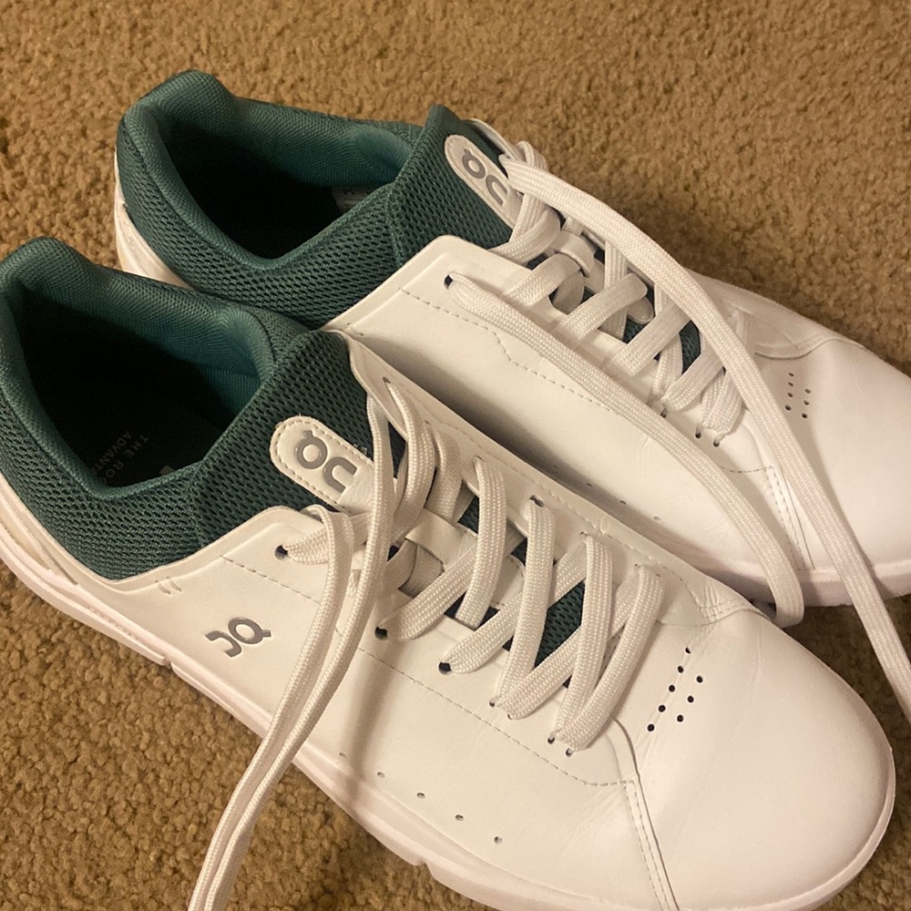 White on cloud sneaker with green back.